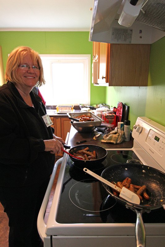 Chair of the Events committee and Chief Sausage Fryer, Katherine Killins, rustles up sausages for the Harvest Breakfast.  2015 Delta Harvest Festival