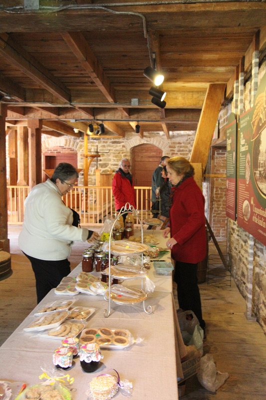 Volunteer Maggie George serves a customer at the Friends of the Mill table.  Delta Harvest Festival 2015