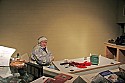Mary Freiday, director and treasurer of The Delta Mill Society, \nmans the desk in the gift shop/entrance.  Mary is one of \nseveral directors and friends of the Delta Mill who volunteer\n their time to greet visitors on a cold December evening\n (so, pop by and say hello!).
