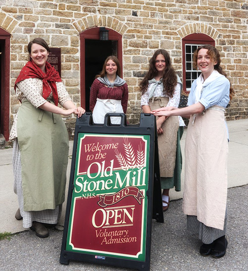 Summer Students with Old Stone Mill Open Sign