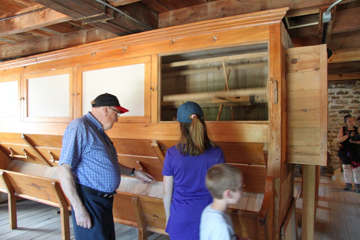 Examining the working bolter\n\nWe have a working bolter on the 2nd floor of the mill. This one in not original to the mill, it in fact pre-dates the mill, built likely in the late 1700s. We installed it here in 2010.\n\nWhile we rarely use it, it is a working bolter which was used to sift flour into various grades. In the early-mid 1800s, only fine flour ("superfine") could be legally exported. To get the fine flour a bolter was needed.
