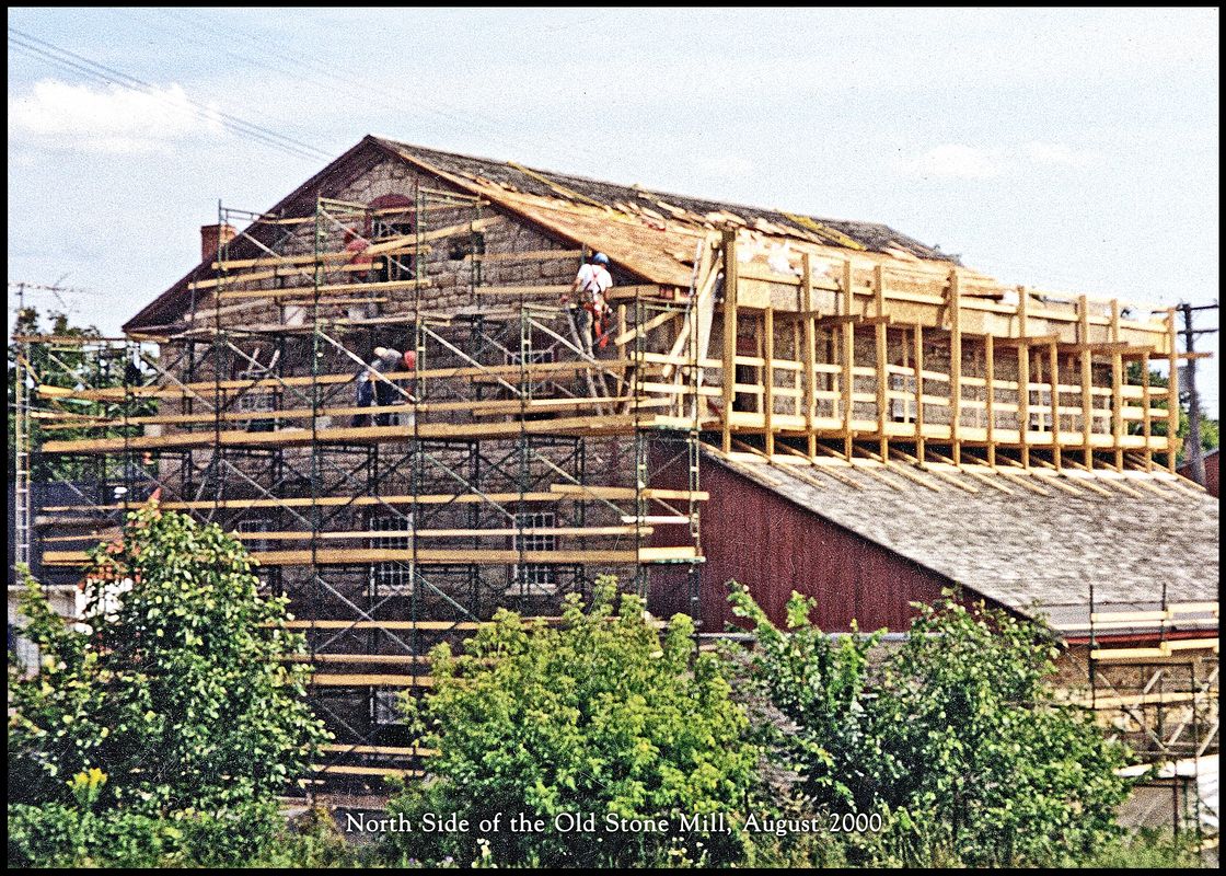 Roof and North Side restoration\nView of the north and west sides of the mill.  The roof is being repaired and reshingled.